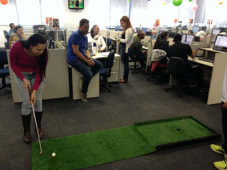 Ativação de marca produzida pela Mistagoo dentro do escritório de um cliente, com pista de golfe montada entre as estações de trabalho
